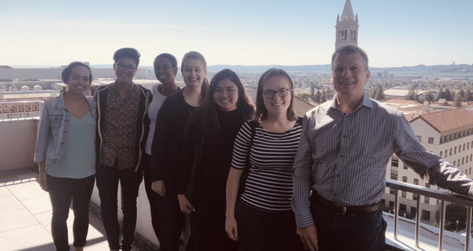 Dr. Alan Sachs with QB3-Berkeley students and postdocs Oct 2019 standing on a balcony in Stanley Hall with views of the UC Berkeley campus.