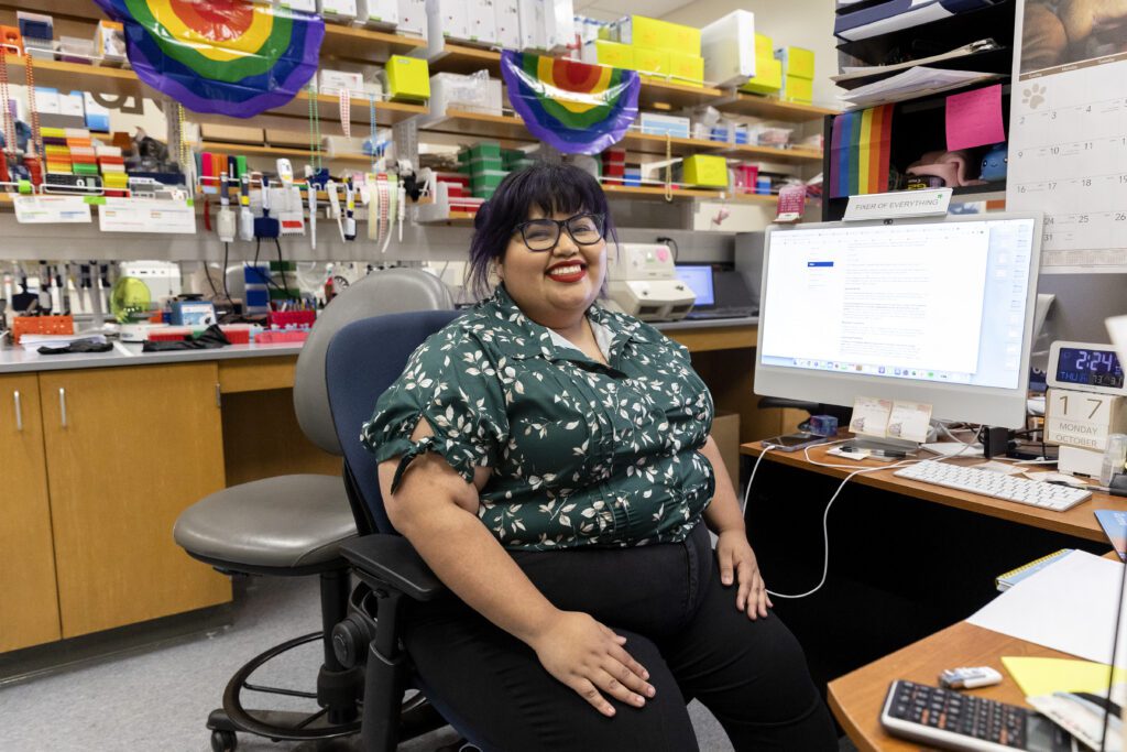 Flo Ramirez seated at a computer in a lab.