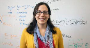 Markita Landry standing in front of a whiteboard with writing